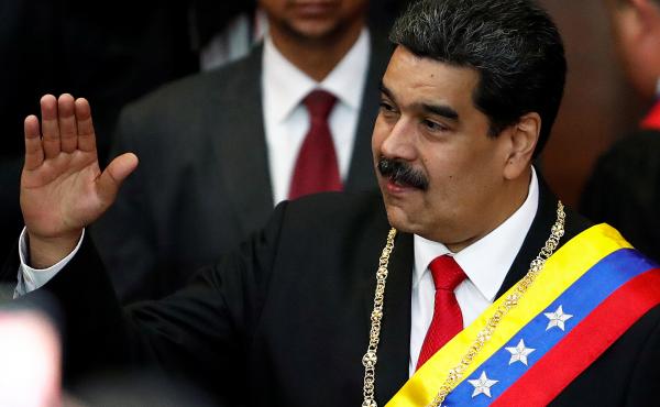 Venezuela's sitting president, Nicolás Maduro, attends a ceremony Thursday in Caracas to mark the opening of the judicial year at the Supreme Court of Justice. Opposition leader Juan Guaidó has declared himself the interim president, but Maduro has not Venezuela's sitting president, Nicolás Maduro, attends a ceremony Thursday in Caracas to mark the opening of the judicial year at the Supreme Court of Justice. Opposition leader Juan Guaidó has declared himself the interim president, but Maduro has not