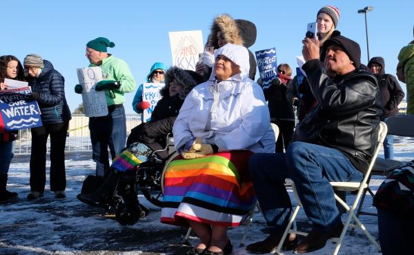 Fort Peck Assiniboine and Sioux council member Patricia Iron Cloud (center) watches protesters make speeches against the Keystone XL pipeline. Fort Peck Assiniboine and Sioux council member Patricia Iron Cloud (center) watches protesters make speeches against the Keystone XL pipeline.