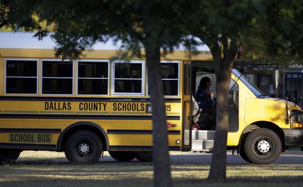 A Dallas Independent School District bus departs L.L. Hotchkiss Elementary school after dropping off students, Thursday, Oct. 2, 2014, in Dallas. A Dallas Independent School District bus departs L.L. Hotchkiss Elementary school after dropping off students, Thursday, Oct. 2, 2014, in Dallas.