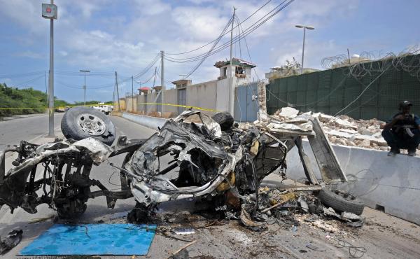 Somali soldiers stand guard next to wreckage from a car bomb outside the U.N.'s office in Mogadishu on Tuesday. At least 13 people were killed in twin bombings near U.N. and African Union buildings adjoining Mogadishu's airport, police said, in what the j Somali soldiers stand guard next to wreckage from a car bomb outside the U.N.'s office in Mogadishu on Tuesday. At least 13 people were killed in twin bombings near U.N. and African Union buildings adjoining Mogadishu's airport, police said, in what the j