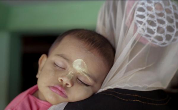 A scene from Midwives: A baby whose face is adorned with thanaka — a kind of sunscreen made from wood bark. A scene from Midwives: A baby whose face is adorned with thanaka — a kind of sunscreen made from wood bark.