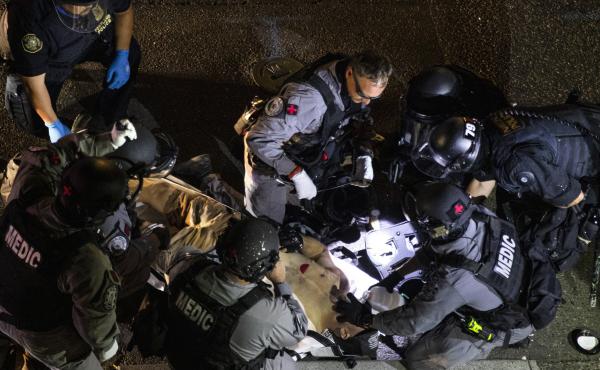 Emergency personnel treat Aaron Danielson in Portland, Ore., on Saturday. The man suspected of killing Danielson, Michael Reinoehl, was killed by law enforcement agents as they attempted to arrest him Thursday night. Emergency personnel treat Aaron Danielson in Portland, Ore., on Saturday. The man suspected of killing Danielson, Michael Reinoehl, was killed by law enforcement agents as they attempted to arrest him Thursday night.
