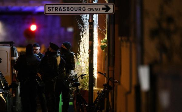 Police officers stand near the place where Cherif Chekatt, the alleged gunman who had been a fugitive since allegedly killing three people at a popular Christmas market in Strasbourg, France, was shot dead by police on Thursday. Police officers stand near the place where Cherif Chekatt, the alleged gunman who had been a fugitive since allegedly killing three people at a popular Christmas market in Strasbourg, France, was shot dead by police on Thursday.