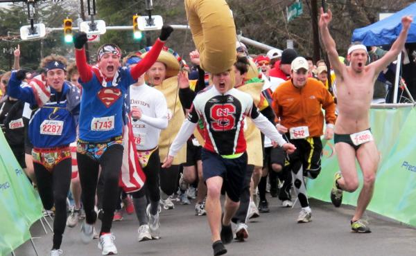 A view from the starting line of the sixth annual Krispy Kreme Challenge in Raleigh, N.C., in 2010. The local children's health clinic takes its name from this annual charity race, which draws about 8,000 participants each year. A view from the starting line of the sixth annual Krispy Kreme Challenge in Raleigh, N.C., in 2010. The local children's health clinic takes its name from this annual charity race, which draws about 8,000 participants each year.