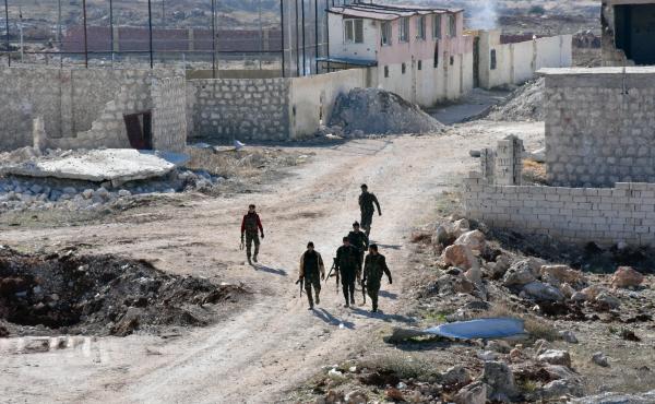 Syrian pro-government forces walk past damaged houses in eastern Aleppo, near Masaken Hanano, on November 23. Syrian pro-government forces walk past damaged houses in eastern Aleppo, near Masaken Hanano, on November 23.