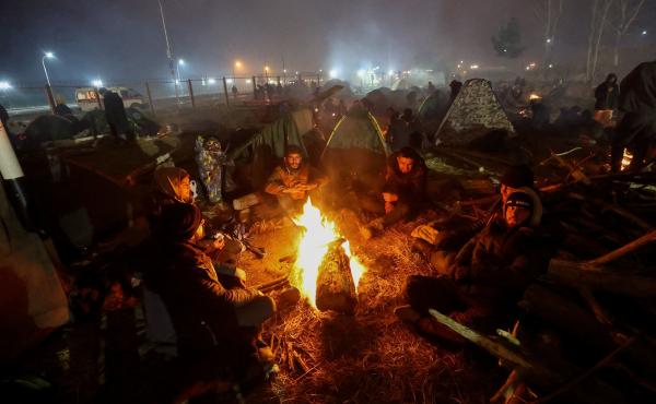 Migrants aiming to cross into Poland camp near the Bruzgi-Kuznica border crossing on the Belarusian-Polish border on Nov. 17. Migrants aiming to cross into Poland camp near the Bruzgi-Kuznica border crossing on the Belarusian-Polish border on Nov. 17.