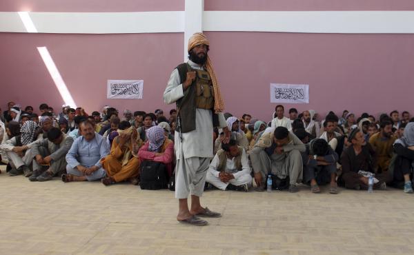 A Taliban fighter stands guard over surrendered Afghan security member forces in the city of Ghazni, southwest of Kabul, Afghanistan, on Friday. A Taliban fighter stands guard over surrendered Afghan security member forces in the city of Ghazni, southwest of Kabul, Afghanistan, on Friday.