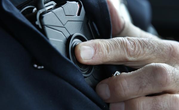A patrol officer in West Valley City, Utah, starts a body camera recording by pressing a button on his chest in March 2015. The West Valley City Police Department issued 190 Axon Flex body cameras for all its sworn officers to wear. A patrol officer in West Valley City, Utah, starts a body camera recording by pressing a button on his chest in March 2015. The West Valley City Police Department issued 190 Axon Flex body cameras for all its sworn officers to wear.
