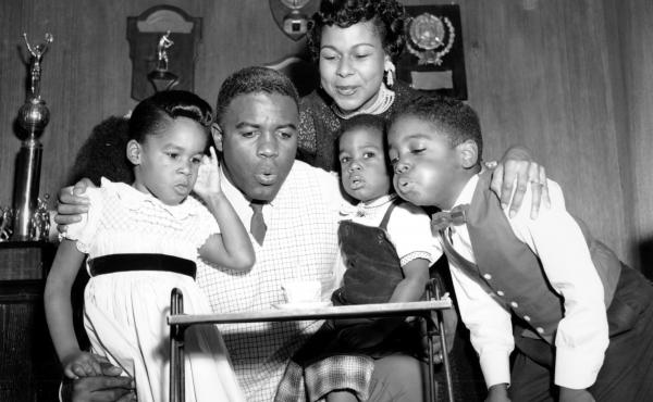 Jackie Robinson draws his family close to help him blow out a birthday candle in 1954. From left, his children Sharon, David, and Jackie Jr., with his wife Rachel, above. Jackie Robinson draws his family close to help him blow out a birthday candle in 1954. From left, his children Sharon, David, and Jackie Jr., with his wife Rachel, above.