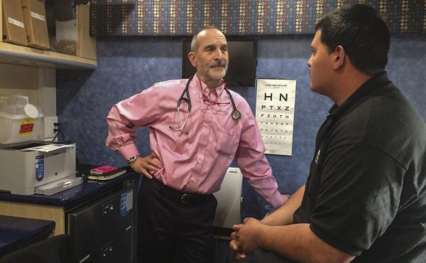 Inside a mobile clinic parked near a Conservation Corp high school, Dr. Seth Ammerman talks with a patient. About 400 young people who visit the van each year have never seen a doctor, Ammerman says. Inside a mobile clinic parked near a Conservation Corp high school, Dr. Seth Ammerman talks with a patient. About 400 young people who visit the van each year have never seen a doctor, Ammerman says.