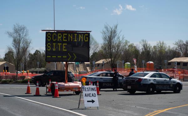 Healthcare professionals screen people at a testing site organized by the Maryland National Guard in a parking lot at FedEx Field on March 30, 2020 in Landover, Md. Healthcare professionals screen people at a testing site organized by the Maryland National Guard in a parking lot at FedEx Field on March 30, 2020 in Landover, Md.