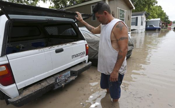 San Marcos, Texas, resident Keith Varela checks out the damage done to his wife's truck in the San Marcos Mobile Home Park on Sunday. San Marcos, Texas, resident Keith Varela checks out the damage done to his wife's truck in the San Marcos Mobile Home Park on Sunday.