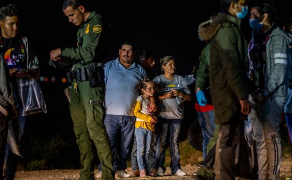 A migrant family stands waiting to be processed on Thursday in Roma, Texas. A migrant family stands waiting to be processed on Thursday in Roma, Texas.