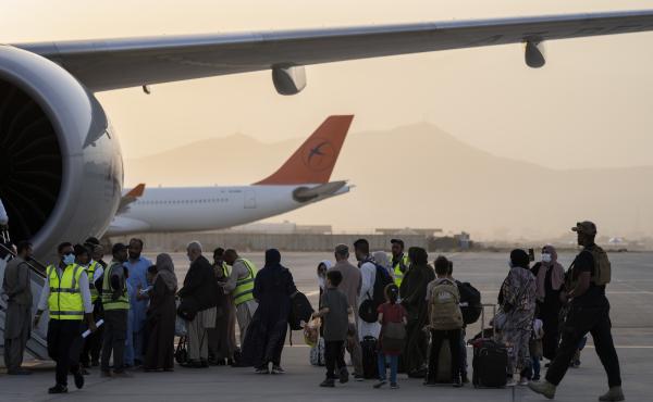 Passengers board a Qatar Airways aircraft at the airport in Kabul, Afghanistan on Thursday. Passengers board a Qatar Airways aircraft at the airport in Kabul, Afghanistan on Thursday.