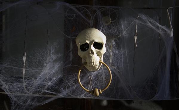 A skull door knocker and cobweb decorations on the day before Halloween in Philadelphia. A skull door knocker and cobweb decorations on the day before Halloween in Philadelphia.