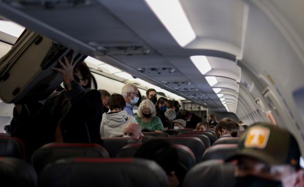 Passengers deplane from an airplane after landing at the Albuquerque International Sunport on Nov. 24, 2021 in Albuquerque, New Mexico. Passengers deplane from an airplane after landing at the Albuquerque International Sunport on Nov. 24, 2021 in Albuquerque, New Mexico.