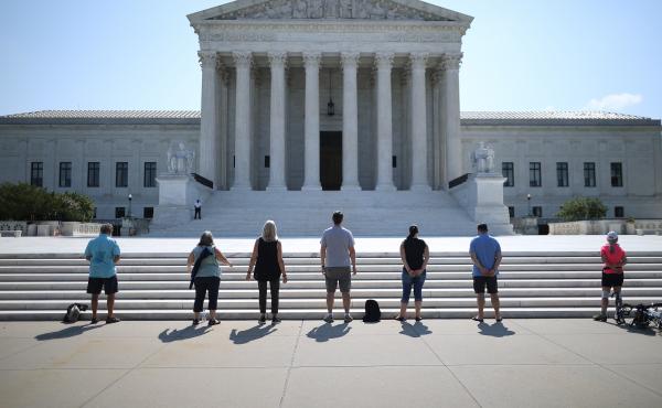 Demonstrators pray in front of the U.S. Supreme Court on July 8, a day the court ruled that employers with religious objections can decline to provide contraception coverage under the Affordable Care Act. With the death of Ruth Bader Ginsburg, the ACA's f Demonstrators pray in front of the U.S. Supreme Court on July 8, a day the court ruled that employers with religious objections can decline to provide contraception coverage under the Affordable Care Act. With the death of Ruth Bader Ginsburg, the ACA's f