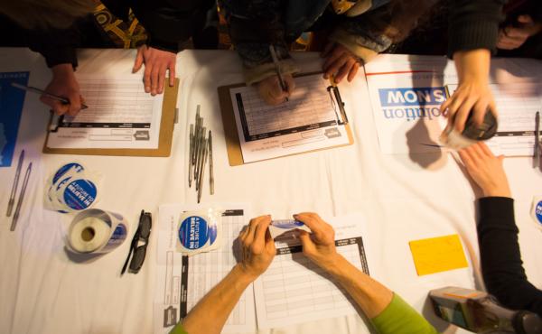 Guests sign in for a Bernie Sanders campaign event in Marshalltown, Iowa, in January. One big question is whether Sanders and outsider Donald Trump, who have been attracting large crowds, can get their supporters to caucus. Guests sign in for a Bernie Sanders campaign event in Marshalltown, Iowa, in January. One big question is whether Sanders and outsider Donald Trump, who have been attracting large crowds, can get their supporters to caucus.
