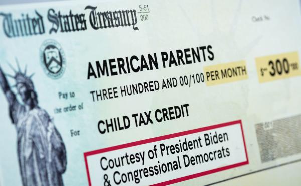 A child tax credit poster is displayed during a news conference in Washington, D.C., on July 15. Early data shows that after the child tax credit payments went out this summer, the number of households with children who experience food insufficiency dropp A child tax credit poster is displayed during a news conference in Washington, D.C., on July 15. Early data shows that after the child tax credit payments went out this summer, the number of households with children who experience food insufficiency dropp