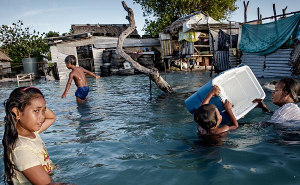 In Kiribati, an island republic in the Central Pacific, large parts of the village Eita (above) have succumbed to flooding from the sea. In Kiribati, an island republic in the Central Pacific, large parts of the village Eita (above) have succumbed to flooding from the sea.