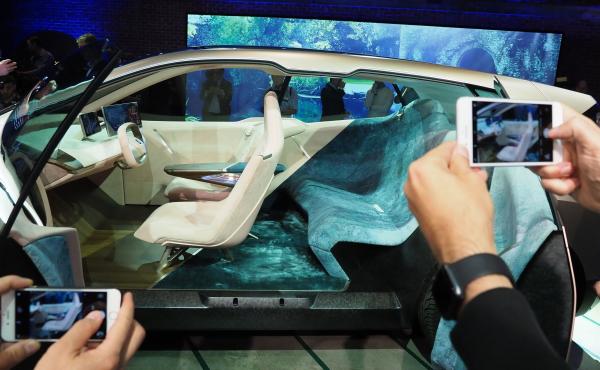 Attendees preview the BMW Vision iNEXT autonomous electric car at a special unveil event ahead of the LA Auto Show on Nov. 27, 2018. Attendees preview the BMW Vision iNEXT autonomous electric car at a special unveil event ahead of the LA Auto Show on Nov. 27, 2018.
