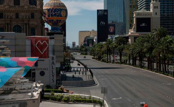 A car drives down an otherwise empty Las Vegas Strip amid the coronavirus pandemic on May 8. A car drives down an otherwise empty Las Vegas Strip amid the coronavirus pandemic on May 8.