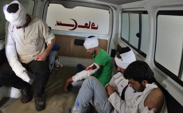 Wounded rebel fighters sit in the back of an ambulance in Aleppo on Thursday. The Syrian government and its Russian allies declared a pause in the fighting and urged rebels to leave the eastern part of the city, but clashes broke out Thursday. Wounded rebel fighters sit in the back of an ambulance in Aleppo on Thursday. The Syrian government and its Russian allies declared a pause in the fighting and urged rebels to leave the eastern part of the city, but clashes broke out Thursday.