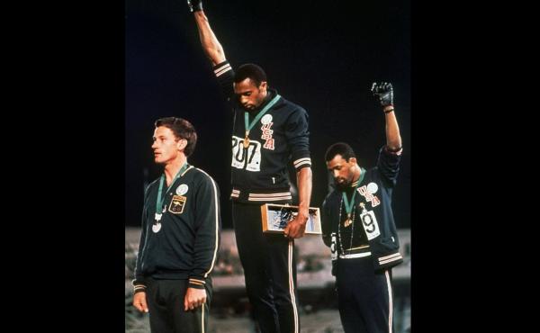 In a famous moment from the 1968 Summer Olympics in Mexico City, U.S. athletes Tommie Smith (center) and John Carlos raise their gloved fists after Smith received the gold medal and Carlos the bronze for the 200-meter run. In a famous moment from the 1968 Summer Olympics in Mexico City, U.S. athletes Tommie Smith (center) and John Carlos raise their gloved fists after Smith received the gold medal and Carlos the bronze for the 200-meter run.