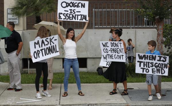 Families protest any potential mask mandates before the Hillsborough County School Board meeting last month in Tampa, Fla. Families protest any potential mask mandates before the Hillsborough County School Board meeting last month in Tampa, Fla.