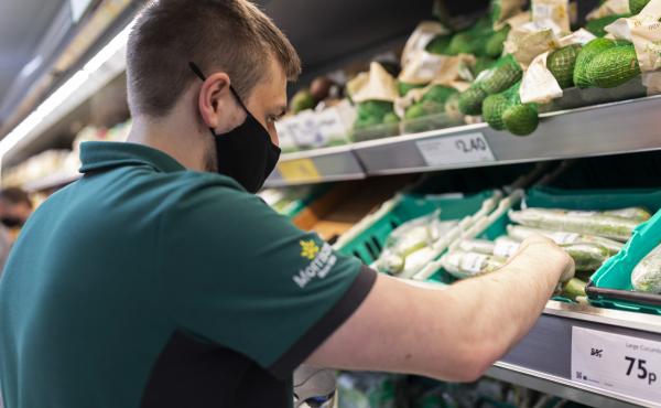 A staff member sorts through fresh produce at British supermarket chain Morrisons last month in Leeds, United Kingdom. A staff member sorts through fresh produce at British supermarket chain Morrisons last month in Leeds, United Kingdom.