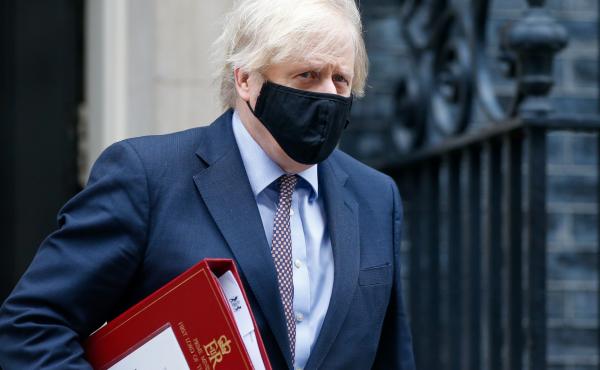 A mask-clad U.K. Prime Minister Boris Johnson departs from No. 10 Downing St. in London in March. A mask-clad U.K. Prime Minister Boris Johnson departs from No. 10 Downing St. in London in March.