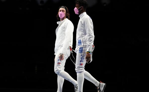 American's Jacob Hoyle and Curtis McDowald wear pink face masks after losing to Japan in Men's Épée. American's Jacob Hoyle and Curtis McDowald wear pink face masks after losing to Japan in Men's Épée.