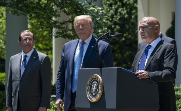 Then-Health and Human Services Secretary Alex Azar (left) and President Donald Trump listen as Moncef Slaoui of Operation Warp Speed speaks about the crash program to develop a COVID-19 vaccine in the White House Rose Garden in May 2020. Then-Health and Human Services Secretary Alex Azar (left) and President Donald Trump listen as Moncef Slaoui of Operation Warp Speed speaks about the crash program to develop a COVID-19 vaccine in the White House Rose Garden in May 2020.