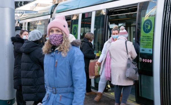 People step off a tram in Nottingham, England, a city where a case of the omicron variant of the coronavirus was identified last week. People step off a tram in Nottingham, England, a city where a case of the omicron variant of the coronavirus was identified last week.