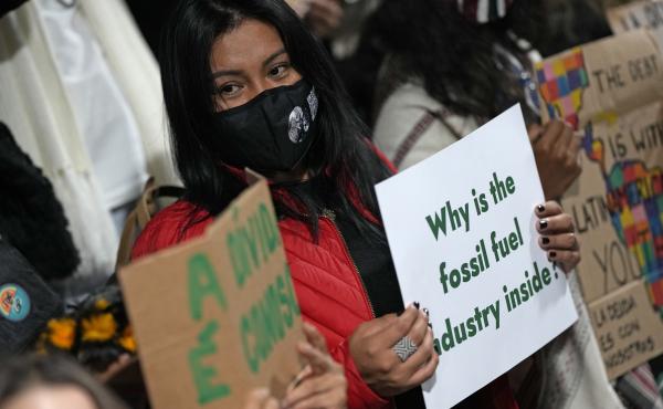 Youth climate activists protest on Thursday that representatives of the fossil fuel industry have been allowed inside the venue during the COP26 U.N. Climate Summit in Glasgow. Youth climate activists protest on Thursday that representatives of the fossil fuel industry have been allowed inside the venue during the COP26 U.N. Climate Summit in Glasgow.