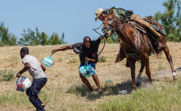 A United States Border Patrol agent on horseback tries to stop a Haitian migrant from entering an encampment on the banks of the Rio Grande near the Acuna Del Rio International Bridge in Del Rio, Texas on Sept. 19, 2021. A United States Border Patrol agent on horseback tries to stop a Haitian migrant from entering an encampment on the banks of the Rio Grande near the Acuna Del Rio International Bridge in Del Rio, Texas on Sept. 19, 2021.