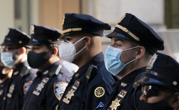 New York Police Department officers in masks stand during a service at St. Patrick's Cathedral in New York, last October. New York Police Department officers in masks stand during a service at St. Patrick's Cathedral in New York, last October.