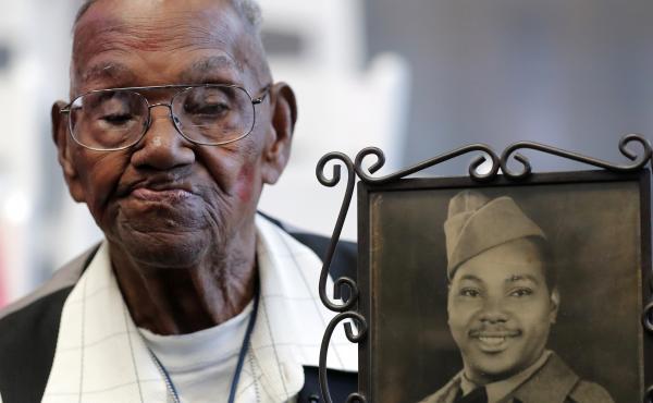 World War II veteran Lawrence Brooks, pictured holding a photo of himself as a soldier in 1943, died on Wednesday at age 112. World War II veteran Lawrence Brooks, pictured holding a photo of himself as a soldier in 1943, died on Wednesday at age 112.