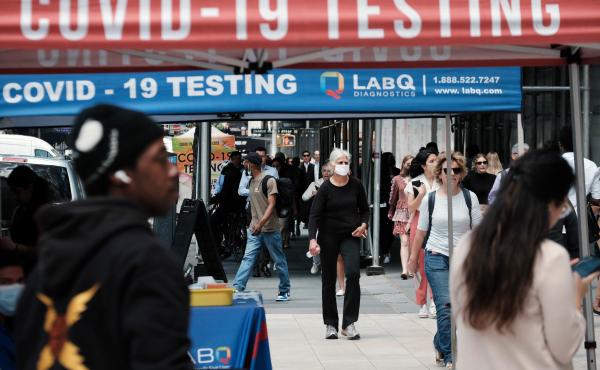 People walk past a COVID testing site on May 17 in New York City. New York's health commissioner, Dr. Ashwin Vasan, has moved from a "medium" COVID-19 alert level to a "high" alert level in all the five boroughs following a surge in cases. People walk past a COVID testing site on May 17 in New York City. New York's health commissioner, Dr. Ashwin Vasan, has moved from a "medium" COVID-19 alert level to a "high" alert level in all the five boroughs following a surge in cases.