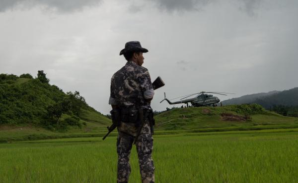 A member of the Myanmar security forces stands guard near a military transport helicopter in Rakhine state last September, about a month into the bloody crackdown on the country's Rohingya Muslim population. A member of the Myanmar security forces stands guard near a military transport helicopter in Rakhine state last September, about a month into the bloody crackdown on the country's Rohingya Muslim population.