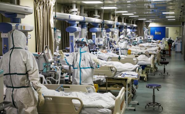 Medical workers in protective suits tend to coronavirus patients at the intensive care unit of a hospital in Wuhan, China. Medical workers in protective suits tend to coronavirus patients at the intensive care unit of a hospital in Wuhan, China.