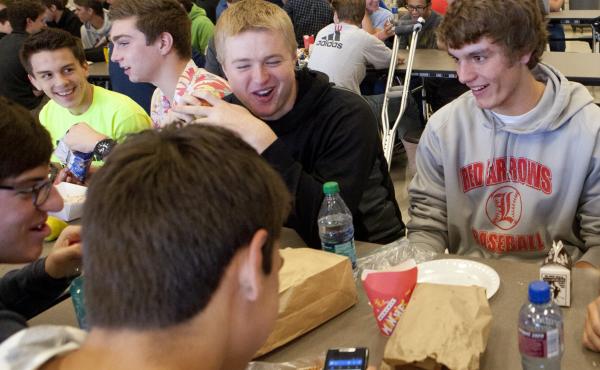 Students at Lowell High School in Michigan sit down for lunch. Shorter lunch breaks mean that many kids don't get enough time to eat and socialize. Students at Lowell High School in Michigan sit down for lunch. Shorter lunch breaks mean that many kids don't get enough time to eat and socialize.