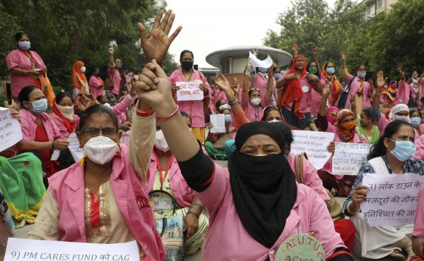 Female community health care workers protest in New Delhi, India, in August 2020. The women are part of a government program called Accredited Social Health Activists — and are demanding higher pay and better working conditions. In May, the program won Female community health care workers protest in New Delhi, India, in August 2020. The women are part of a government program called Accredited Social Health Activists — and are demanding higher pay and better working conditions. In May, the program won
