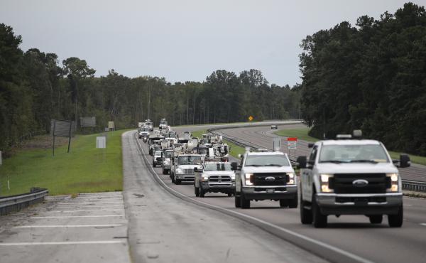 Utility trucks move in Monday as the outer bands of Hurricane Dorian approach in Charleston, S.C. Residents in Charleston and many other coastal areas are under an evacuation order. Utility trucks move in Monday as the outer bands of Hurricane Dorian approach in Charleston, S.C. Residents in Charleston and many other coastal areas are under an evacuation order.