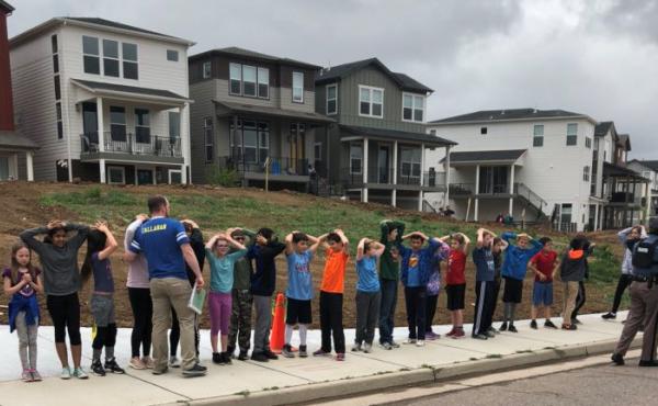 Students line up near STEM School Highlands Ranch during a shooting at the Colorado school that left one dead and eight injured on Tuesday. Students line up near STEM School Highlands Ranch during a shooting at the Colorado school that left one dead and eight injured on Tuesday.