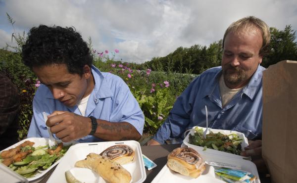 Residents Julio Orsini and Jesse Mackin share a meal together with staff during lunch break in the garden at the Mountain View Correctional Faciltiy in Charleston Maine in August of 2021. Residents Julio Orsini and Jesse Mackin share a meal together with staff during lunch break in the garden at the Mountain View Correctional Faciltiy in Charleston Maine in August of 2021.
