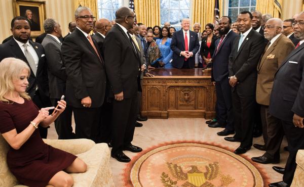 Counselor to the President Kellyanne Conway, left, checks her phone Tuesday after taking a photo as President Trump and leaders of historically black colleges and universities pose for a group photo in the Oval Office. Counselor to the President Kellyanne Conway, left, checks her phone Tuesday after taking a photo as President Trump and leaders of historically black colleges and universities pose for a group photo in the Oval Office.