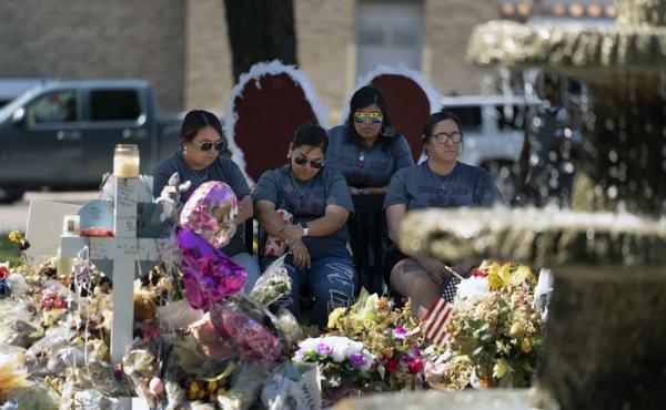 A group of teachers visiting from Dilley, Texas, view a memorial honoring the victims killed in last week's elementary school shooting in Uvalde, Texas, Friday, June 3, 2022. A group of teachers visiting from Dilley, Texas, view a memorial honoring the victims killed in last week's elementary school shooting in Uvalde, Texas, Friday, June 3, 2022.