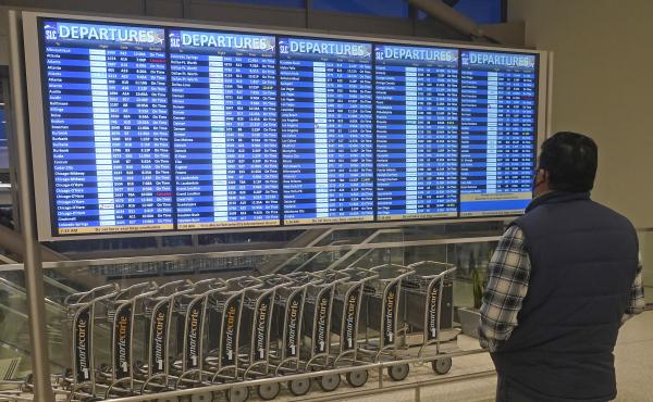 A man looks at the departures board at Salt Lake City International Airport on Friday. Hundreds more flights in the U.S. were canceled on Christmas Day — most involving Chinese airlines, as well as Delta and United in the U.S. A man looks at the departures board at Salt Lake City International Airport on Friday. Hundreds more flights in the U.S. were canceled on Christmas Day — most involving Chinese airlines, as well as Delta and United in the U.S.