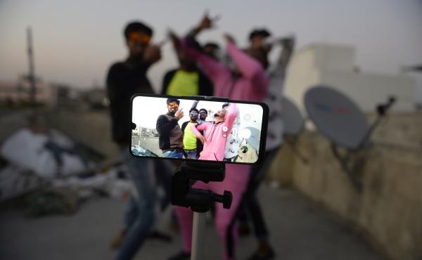 Youths perform in front of a cellphone camera while making a TikTok video on the roof of their residence in Hyderabad, India, in February. India's government has banned 59 Chinese-owned apps including TikTok. Youths perform in front of a cellphone camera while making a TikTok video on the roof of their residence in Hyderabad, India, in February. India's government has banned 59 Chinese-owned apps including TikTok.